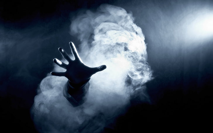 hand sticking out of a smoke cloud